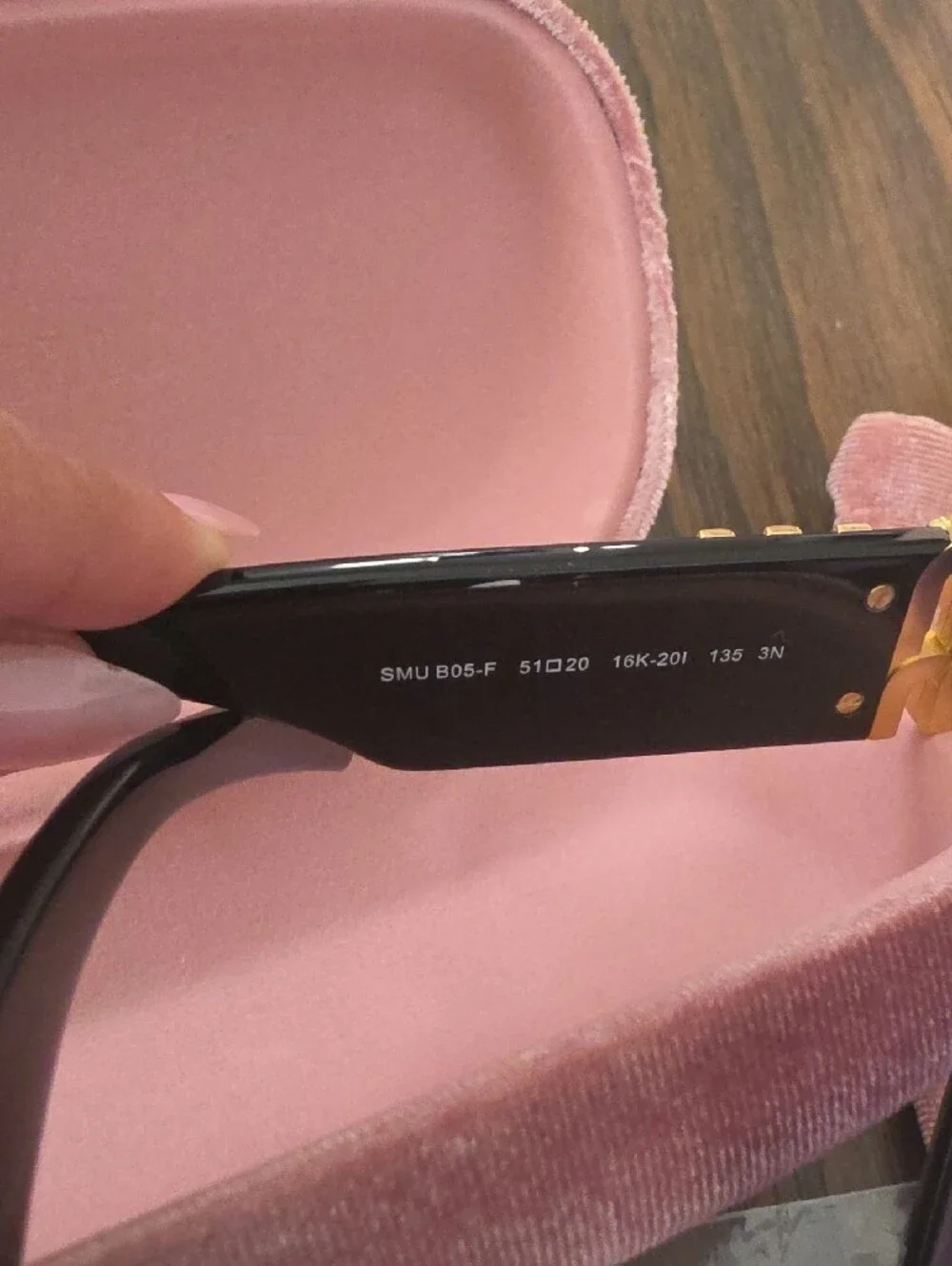 Miu Miu Glossy Black Frame Sunglasses with Purple Lenses